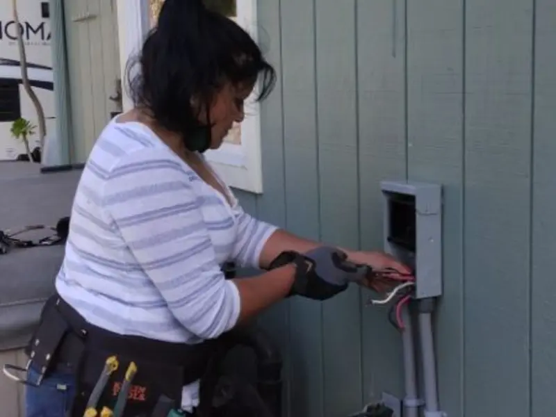 Licensed electrician wiring an exterior subpanel in Los Gatos